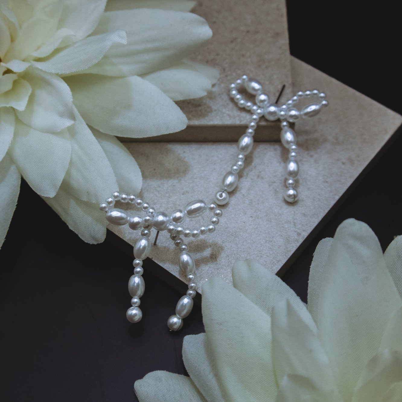 Pearly Bow Earrings on black backdrop